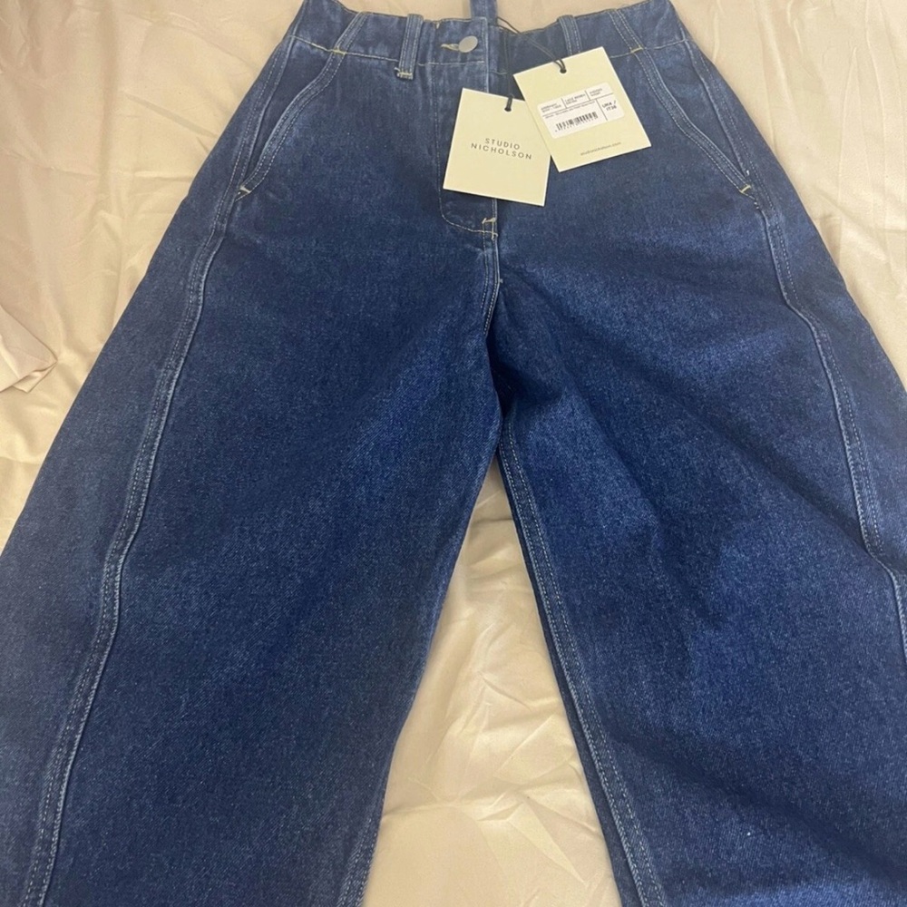 Studio Nicholson Indigo wash Denim rounded leg twist seam pants for Women